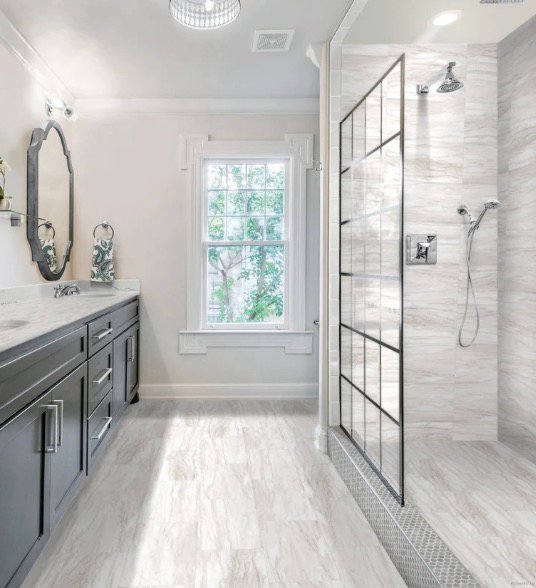 Bathroom remodel with marble-look walk-in shower and gray vanity