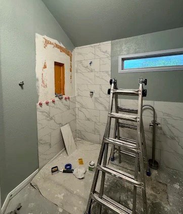 Bathroom tile installation progress during remodel