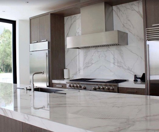 Modern kitchen with marble-look counters and backsplash