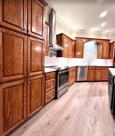 Kitchen update with oak cabinetry, backsplash, and modern flooring