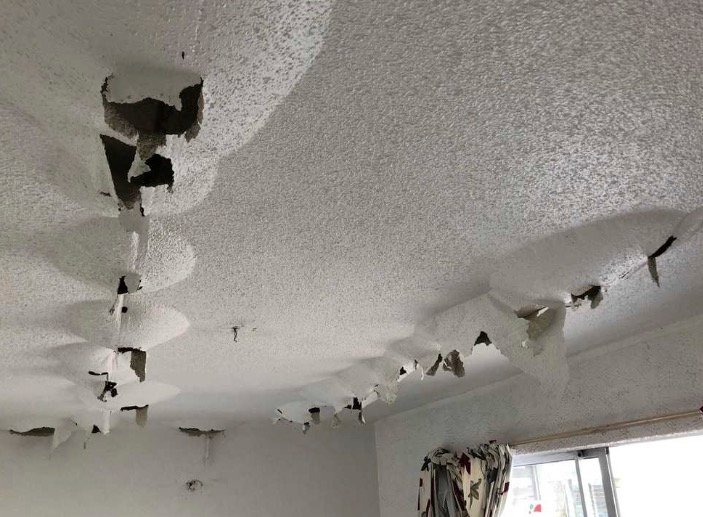 Ceiling material opened for water mitigation and dryout