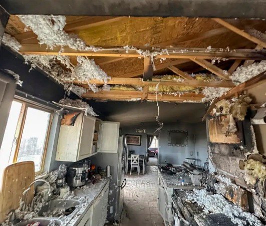 Fire-damaged kitchen prepared for cleanup and reconstruction