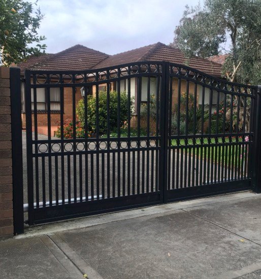 Decorative black metal driveway gate