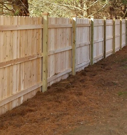 Traditional wood privacy fence along a property line